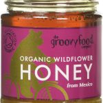 Jar of The Groovy Food Company organic wildflower honey from Mexico with purple label featuring a bear on a bike